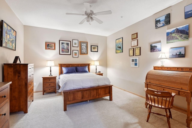 bedroom featuring light carpet, ceiling fan, and baseboards