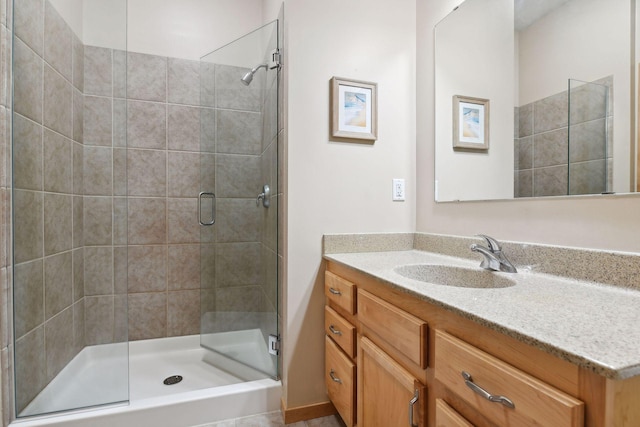 full bath with a stall shower and vanity