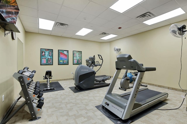 workout area with a paneled ceiling, carpet, and visible vents