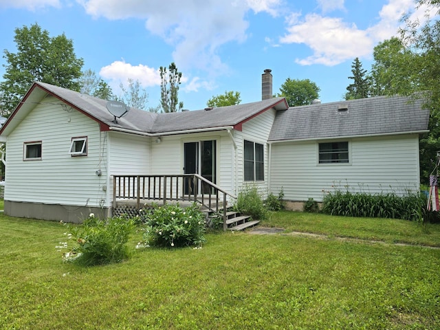 back of property featuring a yard and a deck