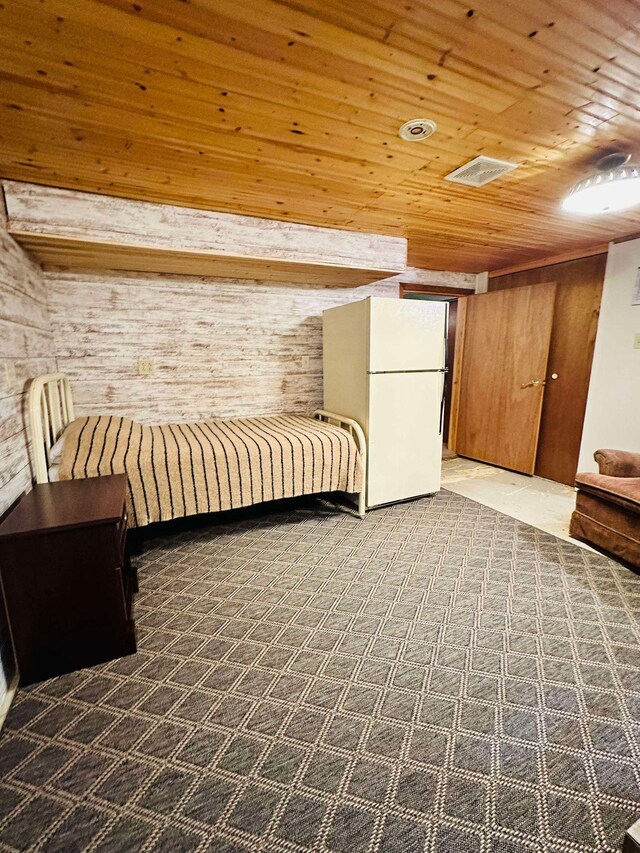 unfurnished bedroom featuring white refrigerator and wooden ceiling