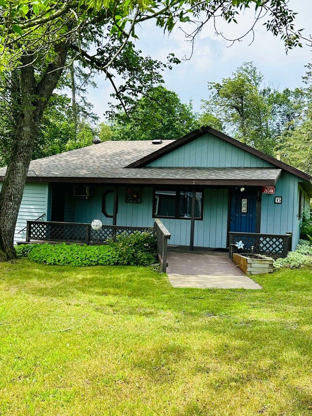 rear view of property with a lawn