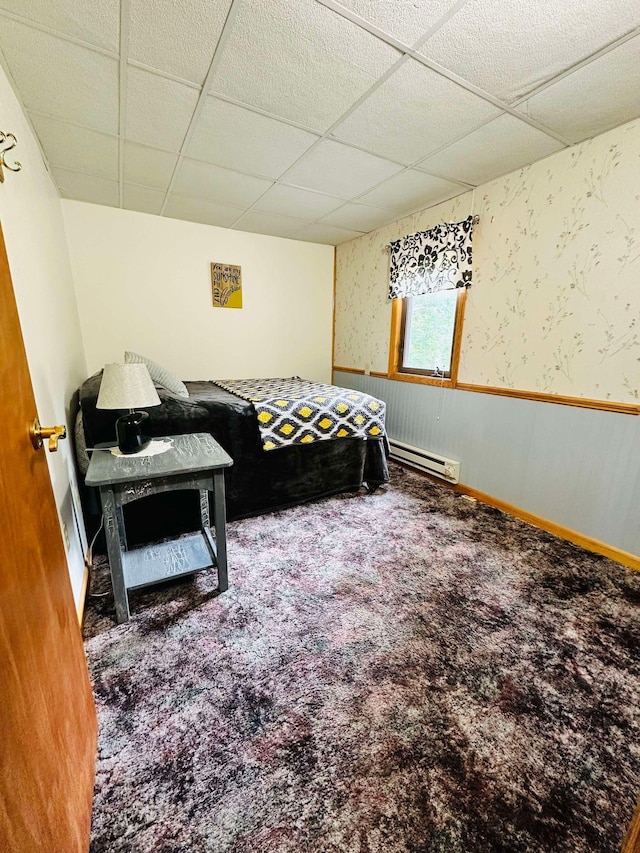 bedroom featuring a baseboard radiator, carpet floors, and a paneled ceiling