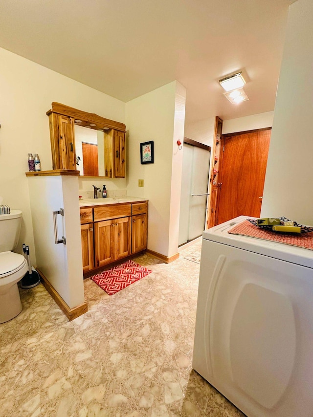 interior space featuring washer / clothes dryer, sink, and light tile patterned flooring