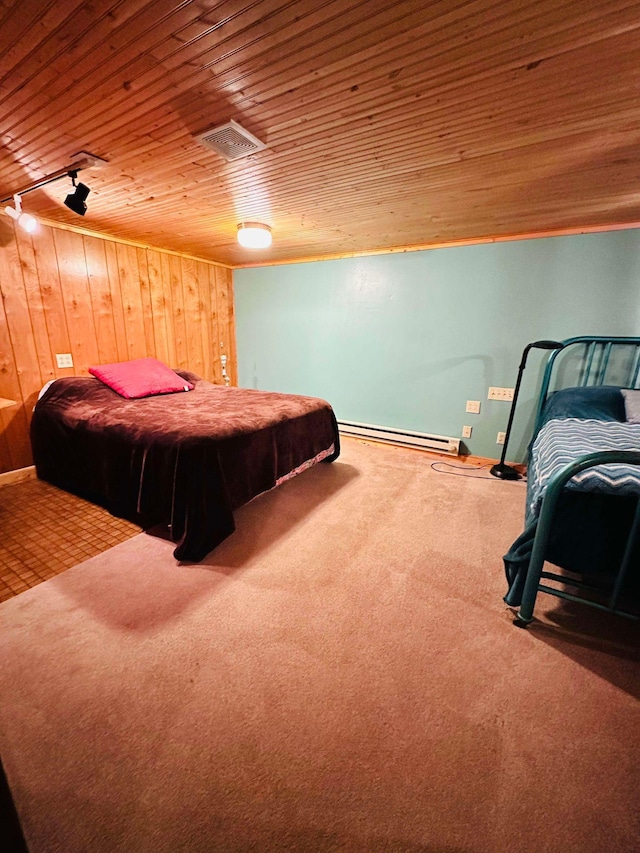 carpeted bedroom with wood walls, wooden ceiling, and a baseboard heating unit