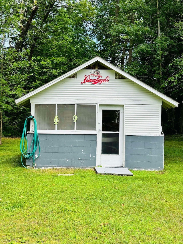 view of outbuilding with a yard