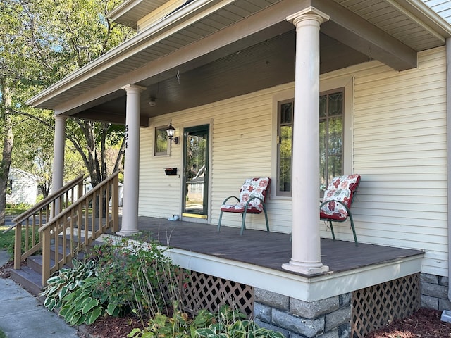 view of exterior entry featuring covered porch