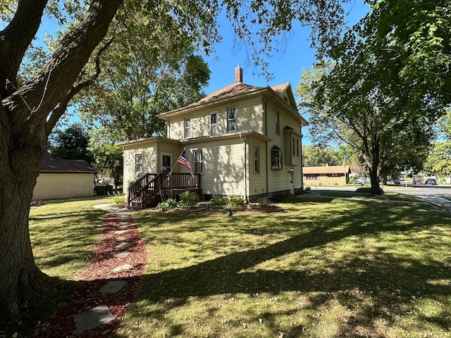 view of front of property featuring a front lawn and a chimney