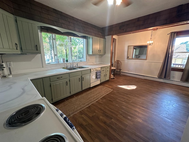 kitchen featuring a baseboard heating unit, white appliances, a sink, a wealth of natural light, and green cabinetry