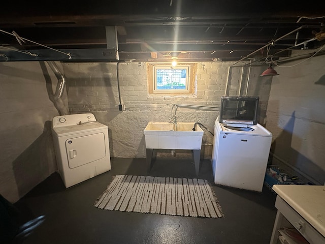 below grade area featuring independent washer and dryer, a sink, and fridge