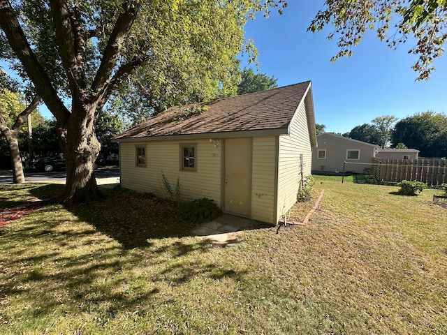 view of outbuilding with an outbuilding and fence