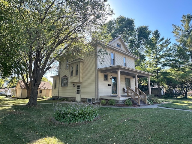 american foursquare style home featuring a porch and a front lawn