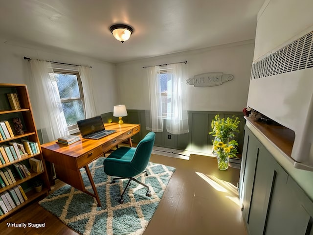 office space featuring a wainscoted wall, dark wood finished floors, and a decorative wall