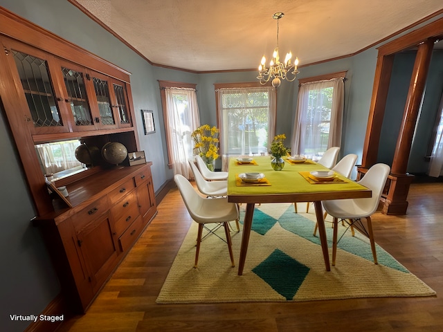 dining room with baseboards, a notable chandelier, ornamental molding, and dark wood-style flooring