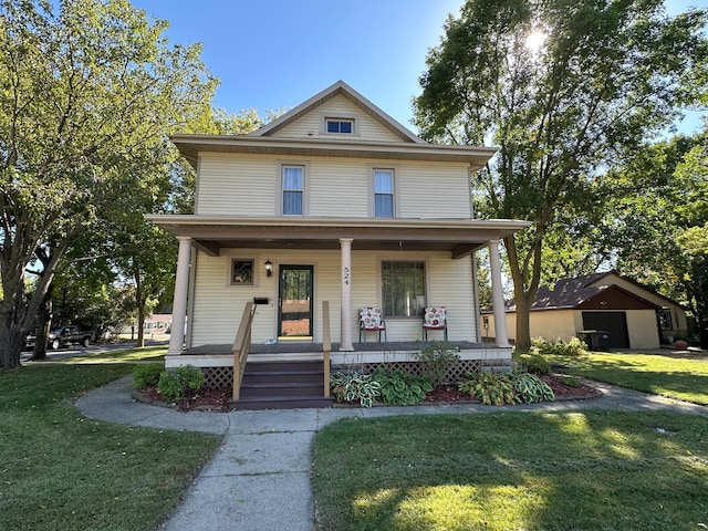 american foursquare style home featuring a porch and a front yard