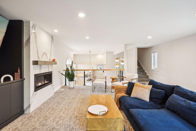 living room featuring a fireplace and carpet flooring