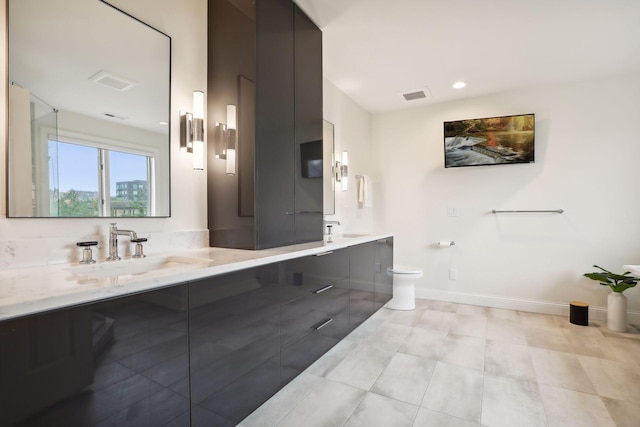 bathroom with tile patterned flooring, toilet, and vanity