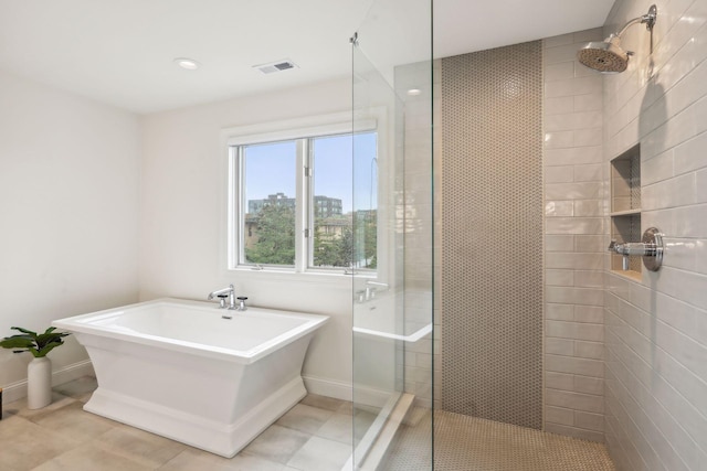 bathroom with independent shower and bath and tile patterned floors