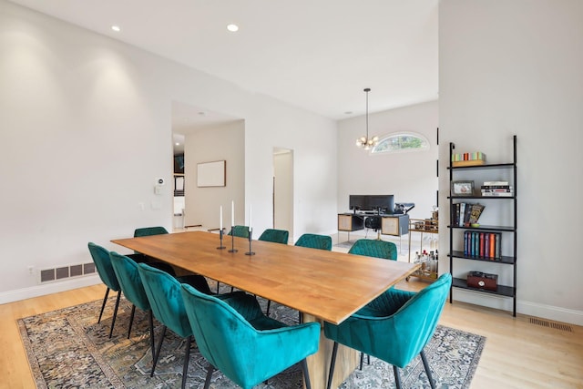 dining room featuring an inviting chandelier and light hardwood / wood-style floors