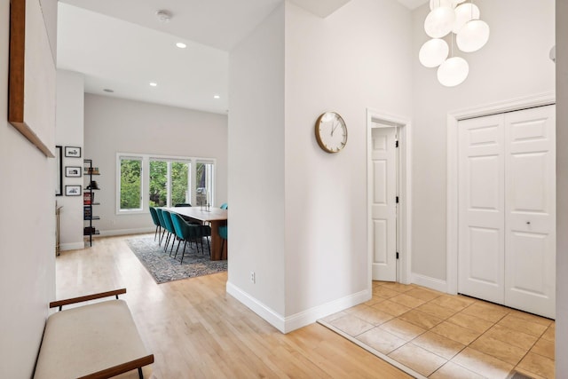 foyer entrance featuring an inviting chandelier and light hardwood / wood-style floors