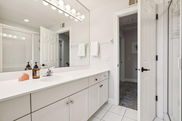 bathroom with vanity, tile patterned floors, and walk in shower