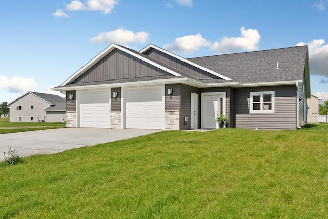 view of front of home with a front lawn, stone siding, concrete driveway, an attached garage, and a shingled roof