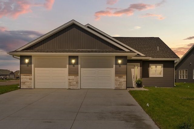 view of front of house with concrete driveway, a garage, a front yard, and stone siding