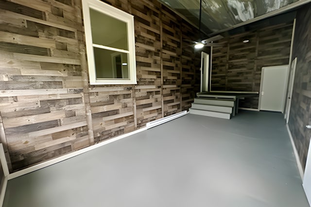 basement featuring wooden walls