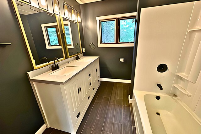 bathroom featuring vanity and bathing tub / shower combination