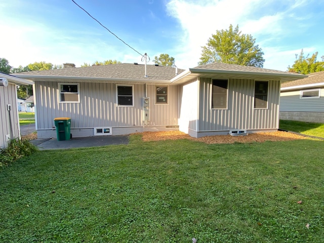 back of property featuring a lawn