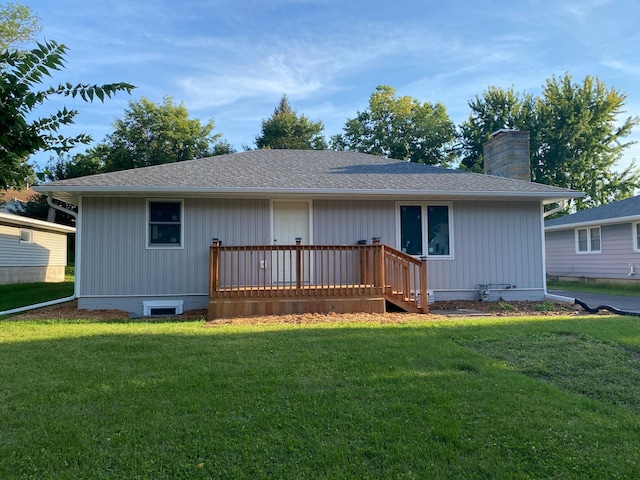 view of front of home with a front yard and a deck