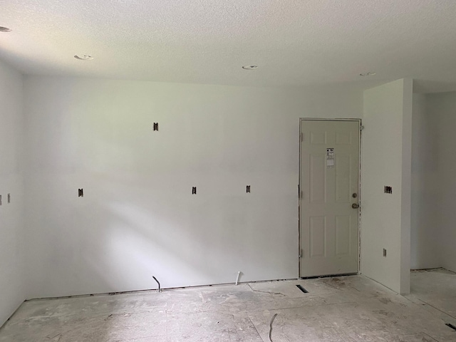 spare room featuring a textured ceiling