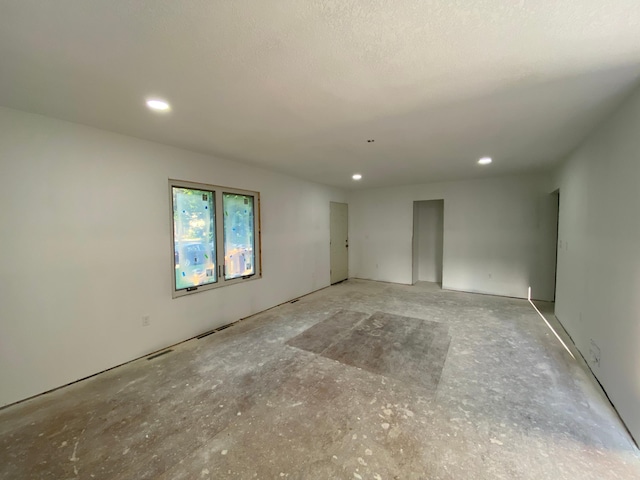 unfurnished room featuring a textured ceiling