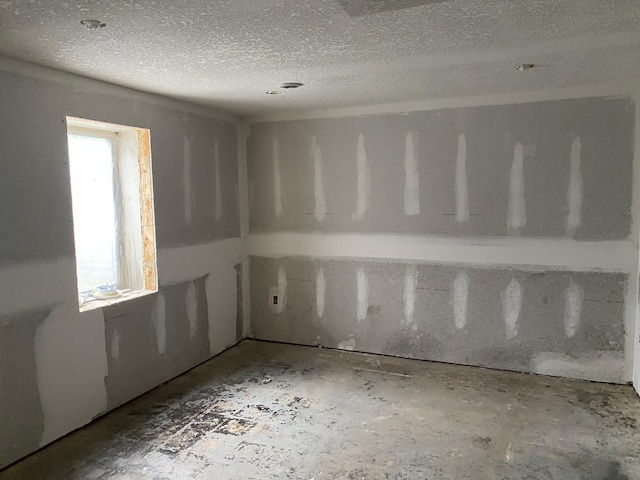 empty room featuring a textured ceiling