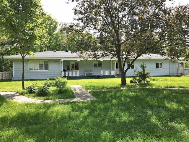 20761 Moose Point Rd, Grand Rapids, MN 55744 - ranch-style house featuring a porch, fence, and a front lawn