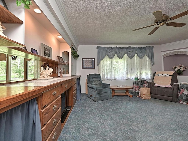 interior space with crown molding, a textured ceiling, ceiling fan, and carpet floors