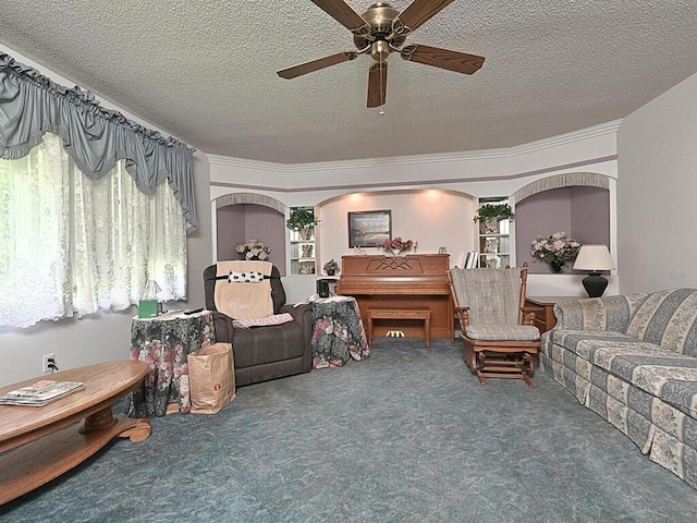 carpeted living room featuring a textured ceiling and ceiling fan