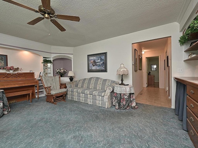 carpeted living room featuring a textured ceiling and ceiling fan