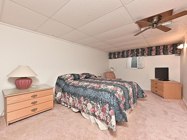 bedroom with a drop ceiling, ceiling fan, and carpet