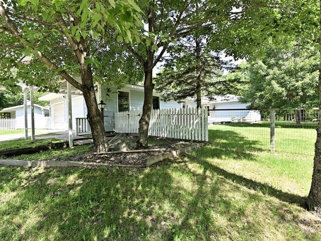 20761 Moose Point Rd, Grand Rapids, MN 55744 - view of yard featuring an attached garage and fence