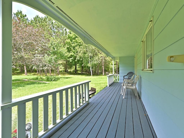 wooden deck featuring a yard