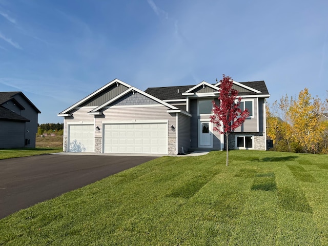 view of front of home with a garage and a front lawn