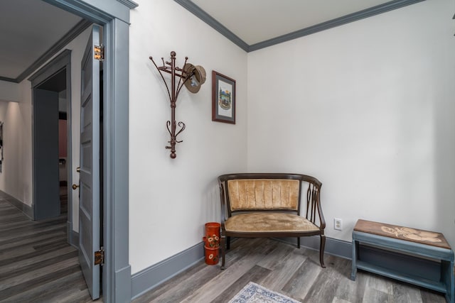 living area featuring ornamental molding and dark hardwood / wood-style flooring