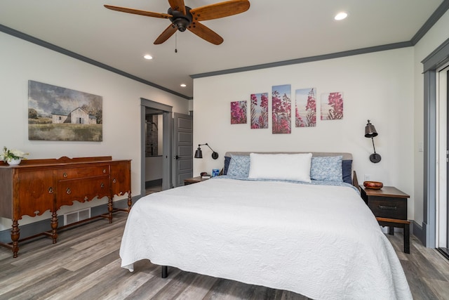 bedroom featuring ceiling fan, ornamental molding, and wood-type flooring