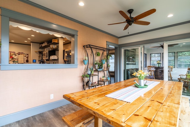 dining space with ornamental molding and wood-type flooring