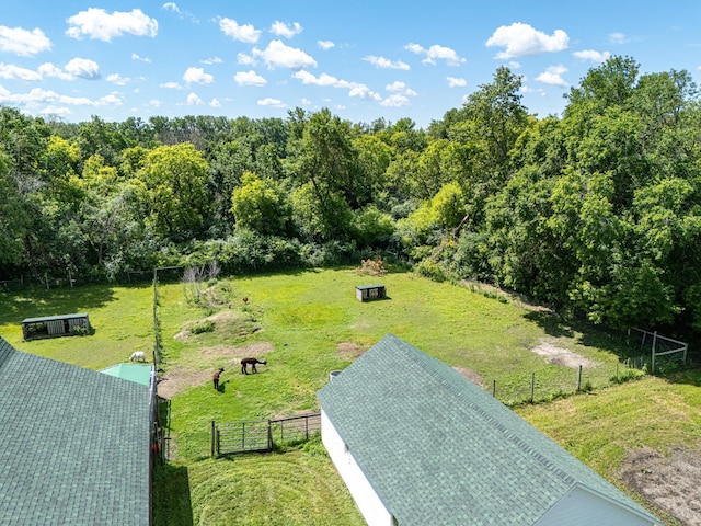 view of property's community featuring an outdoor structure and a lawn