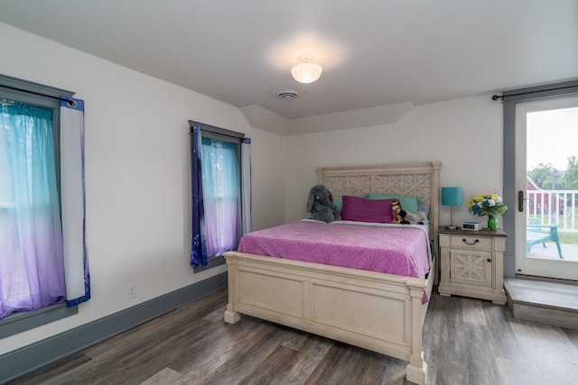 bedroom with access to outside and dark hardwood / wood-style flooring