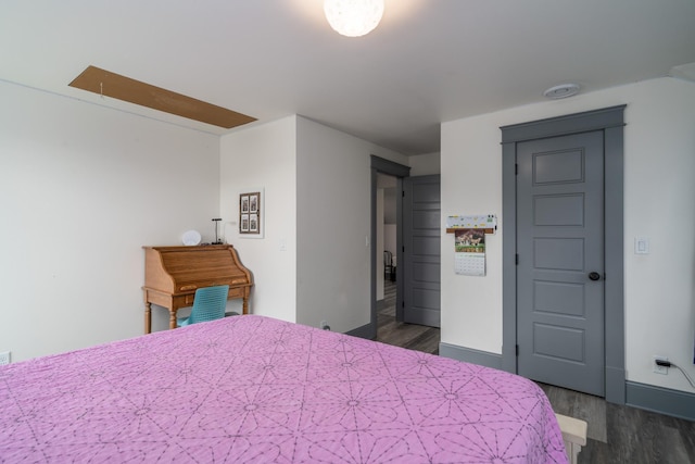 bedroom with dark wood-type flooring