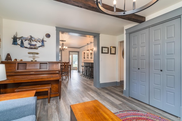 foyer entrance with beam ceiling, a chandelier, and dark hardwood / wood-style floors