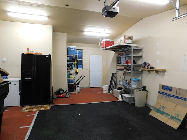 garage with black fridge and a garage door opener